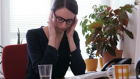 Sick at work - A young secretary taking a pill for a headache Video stock 87182197