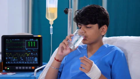 A sick young boy is having his medicines with a glass of water - prescribed m... Stock Footage 260815674