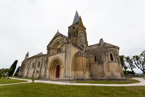 Side, abse and tower views of aulnay de saintonge church Stock Photos