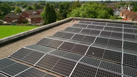 Side-on advancing aerial video of a solar panel array filmed on a bright and Stock Footage 314783701
