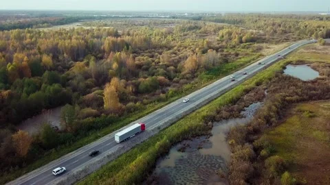 Side aerial view of cargo semi truck pulling off the highway to the roadside 動画素材 166546645