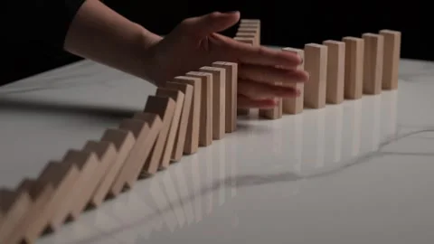 Side-angle 4K slow-motion perspective of dominoes falling Stock Footage 293257652