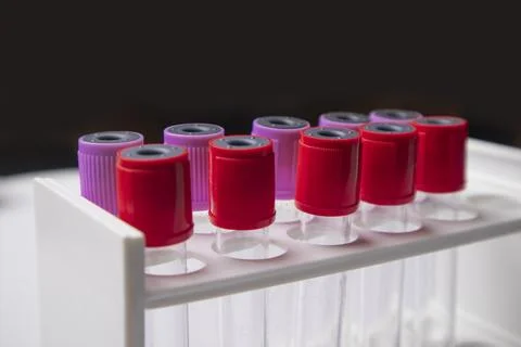 Side-angle, close-up shot of multiple medical blood collection tubes with r.. Stock Photos
