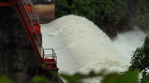 Side angle of dam water release, heavy current with foam and turbulent splash. Stock Footage 315569037