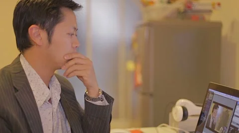 Side angle - elegant young  asian businessman works on laptop Stock Footage 46813392