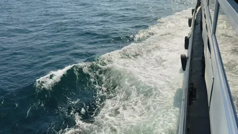 Side angle of a ferry moving across the Bosphorus with clear view of the foamy Stock Footage 323487245