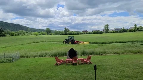 Side angle of haying our field with firepit in foreground Video stock 202341629