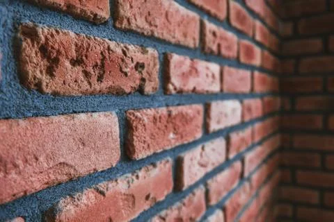Side angle of a red brick wall corner. Modern interior design, unique Stock Photos