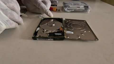 SIDE ANGLE SCENE TECHNICIAN REPAIRING COMPUTER HARD DISK Stock Footage 247817944