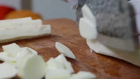 Side angle shot of peeled white Chinese yam being sliced into pieces. 動画素材 341836255