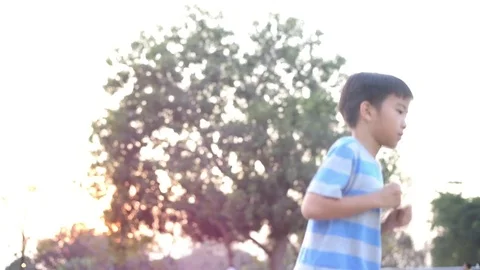 Side angle of slow motion of happy running Asian boy with light effect Stock Footage 85076508