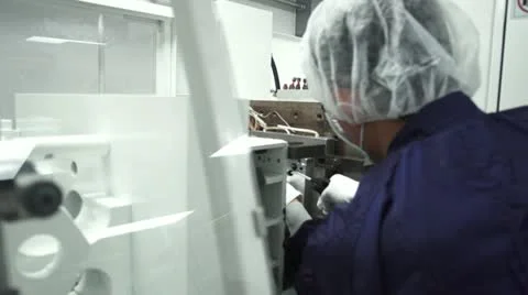 Side angle of Technician Working in Machine in Cleanroom Stock Footage 10895675