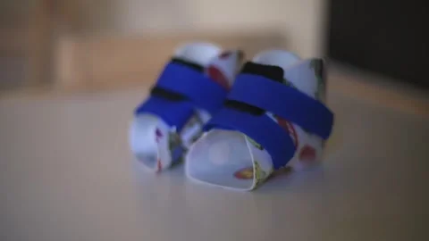 Side-angle view of children orthopedic shoes featuring blue straps playful 動画素材 295838051