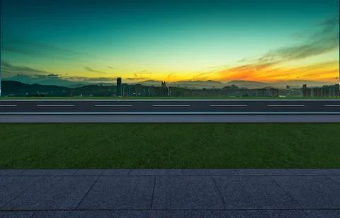 Side angle view empty asphalt road with grass ,stone marble floor and sunrise Stock Photos
