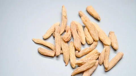 Side angle view herb MaiDong or Ophiopogonis Radix or Dwarf Lilyturf Root Tub Stock Footage 145804365