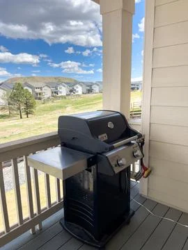 Side Angle of Weber Grill on Covered Deck Stock Photos