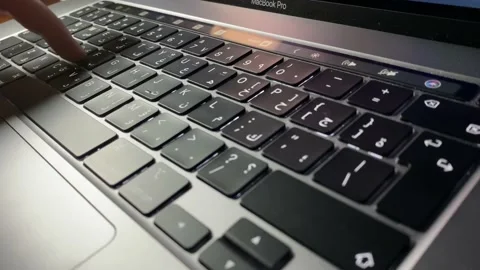 Side angle of a woman typing on a keyboard Stock Footage