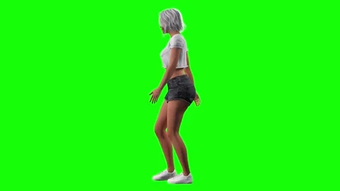 Side angle of woman walking smoothly with catwalk influence on green Stock Footage 328636679