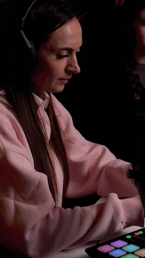 Side angle of young female podcaster and her guest. Vertical video Stock Footage 235437555