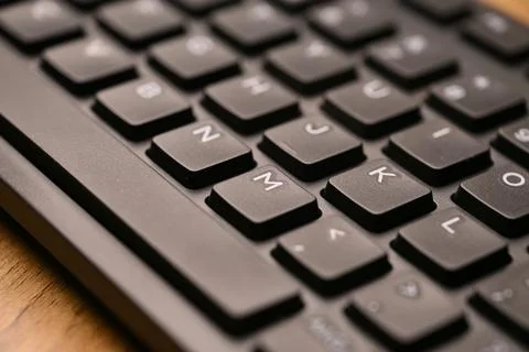 Side Angled Top View Macro Close-Up Black Computer Keyboard Highlighting M .. Stock Photos