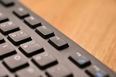 Side Angled Top View Macro Close-Up Black Computer Keyboard Highlighting F8.. Foto stock