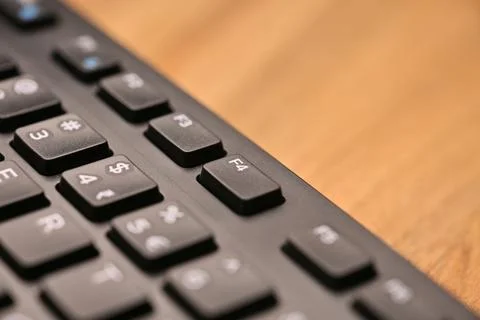 Side Angled Top View Macro Close-Up Black Computer Keyboard Highlighting F4.. Foto stock