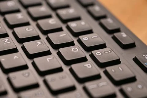 Side Angled Top View Macro Close-Up Black Computer Keyboard Highlighting O .. Stock Photos