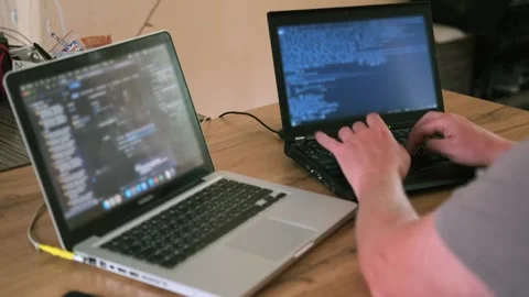 Side back view man hands writing code on laptop Stock Footage 243583947