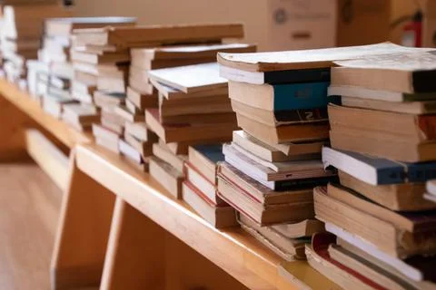 Side of books bunch on a bench inside Stock Photos
