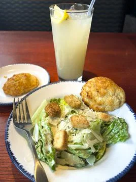 Side Caesar Salad Ice Cold Lemonade at a Sea Food Restaurant Stock Photos