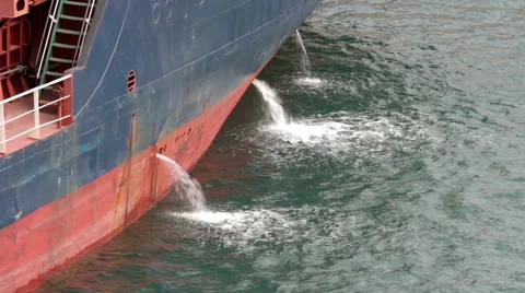 Side of cargo ship where the water gets out to maintain the balance of the ship Stock-Footage 61394860