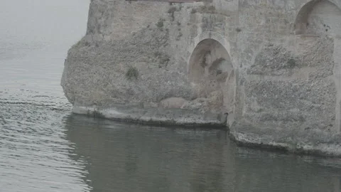 Side of castle wall dipping arches in the water 4K Stock Footage 165593010