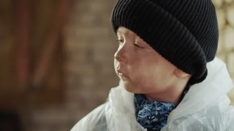 Side Close Up of Boy Wearing Hat Looking Focused and Observant Video stock 329463819
