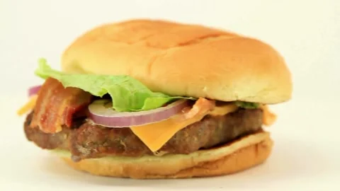 Side Close Up Of A Burger Rotating tomato, close-up view lettuce and mayonnaise Video stock 336579198