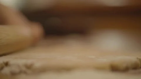 Side close-up of child rolling pin on dough Stock Footage 336374552