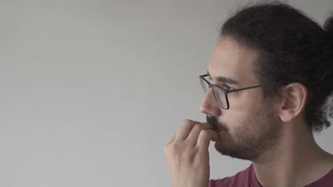 Side close up  with copy space of distracted young man biting his nails Stock Footage 161552299