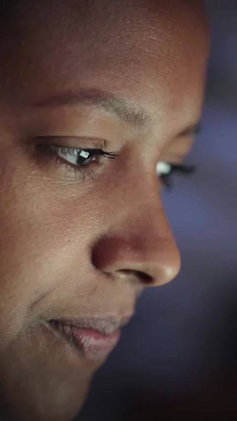Side close-up face beautiful young American black woman looking at screen Stock Footage 260847875