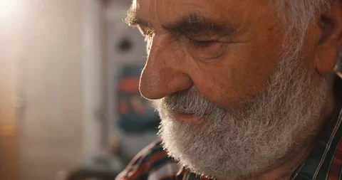 Side close-up portrait of the confident aged senior man with gray beard. 4k Stock Footage 123503507