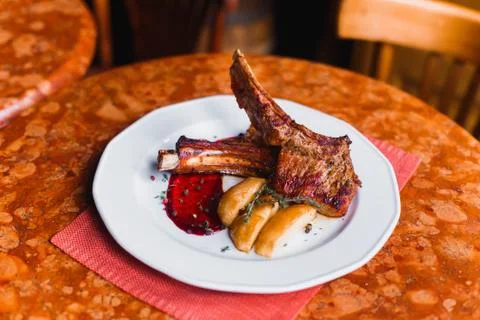 The side close-up view of the food composition of the fried potatoes, grilled Stock Photos