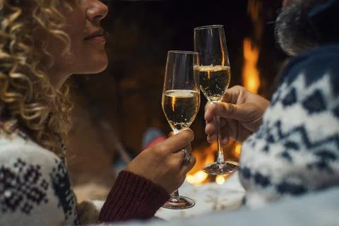 Side close up view of romantic couple celebrating together drinking champagne Foto stock