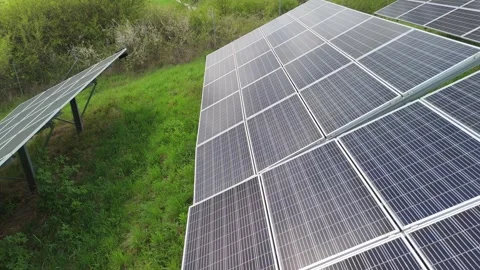Side close-up view of solar panels on green meadow, renewable energy production Stock-Footage 314406447