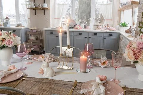 Side closeup view on romantic cute table decor with glasses flowers and lit c Stock Photos