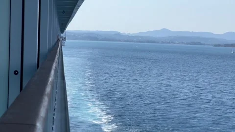 Side of cruise ship along the waterfront under a clear blue sky Stock Footage 345259493