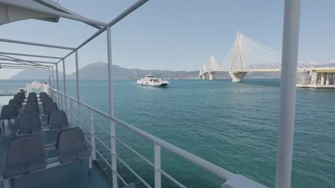 Side deck seats with sea view and ro ro ferry under bridge scene Stock Footage 338108803