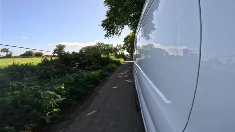 Side Of Delivery Van Driving On Country Road In Ireland. closeup shot Stock Footage 263204626