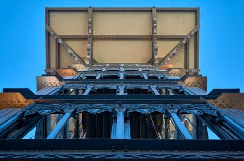 Side detail of a view from below of the structure of a metal tower with eleva Stock Photos