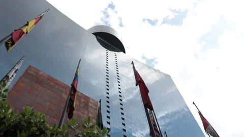 Side diagonal low-angle shot of Mexico City's World Trade Center and its flags. Video stock 158779025
