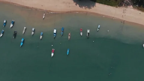 Side down with the camera down. In the frame a lot of tourist boats. Langkawi Video stock 106808275