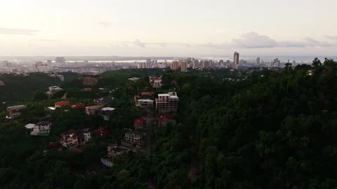 Side drone flight over Cebu City skyline and hillside homes sunrise Vidéo 334089527