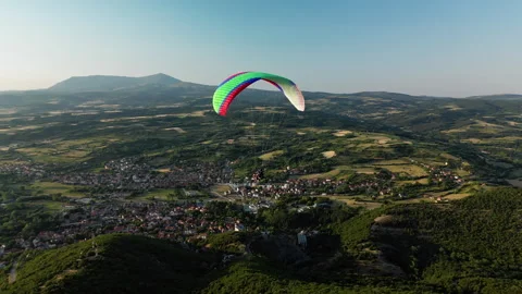 Side drone shot left to right of paraglider over Sokobanja with Rtanj Mountain Stock Footage 328540562